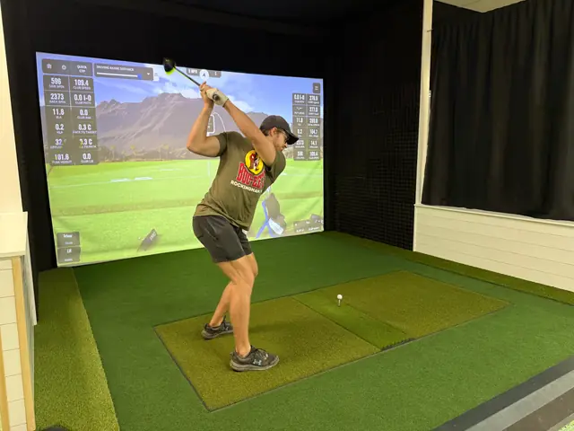 A golfer mid-swing in a bay